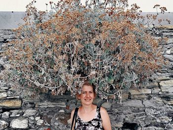 Portrait of young woman standing outdoors