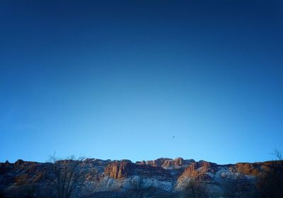 Scenic view of mountains against clear blue sky