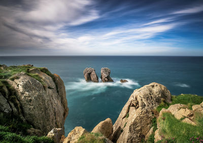 Panoramic view of rocks on sea against sky