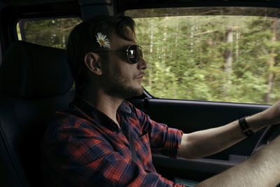 Man wearing flower while driving car