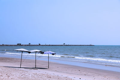 Scenic view of beach against clear sky
