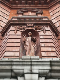 Low angle view of statue against building