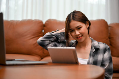 Young woman using laptop at home