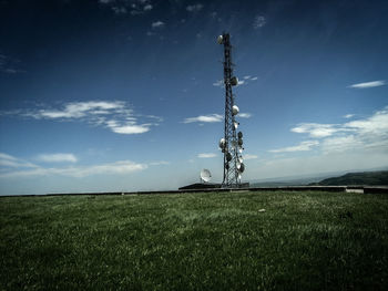 Windmill on field against sky