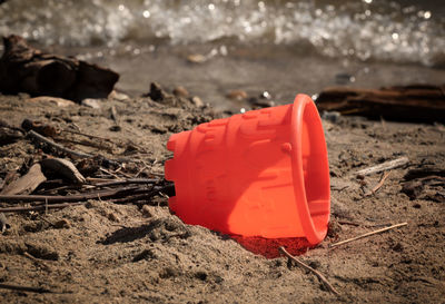 Close-up of red toy on beach