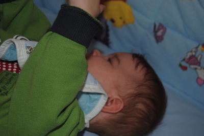 High angle view of baby sleeping on bed