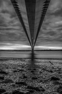 Low angle view of bridge over sea against sky