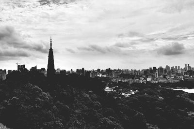 Cityscape against cloudy sky