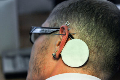 Close-up of man with pierced ear