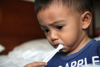 Close-up of cute boy brushing teeth