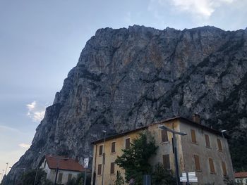 Low angle view of buildings and mountain against sky