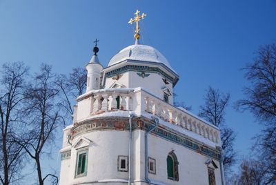 Low angle view of building and trees against sky