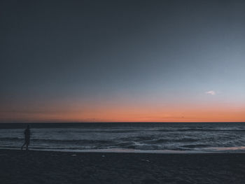 Scenic view of sea against clear sky during sunset