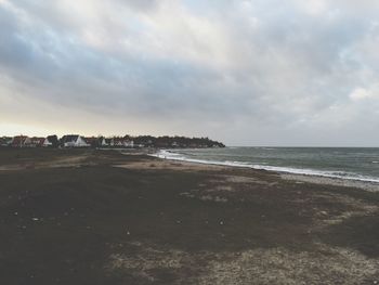 Scenic view of sea against cloudy sky