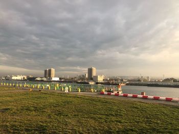 Scenic view of river by buildings against sky