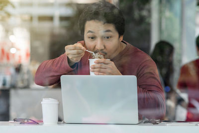 Portrait of mature man eating food