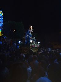 Statue of people at music concert at night