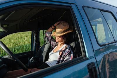 Smiling woman sitting in car