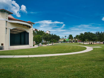 Lawn by building against sky