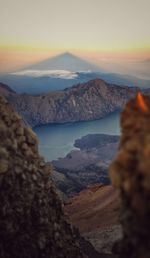 Scenic view of sea and mountains against sky