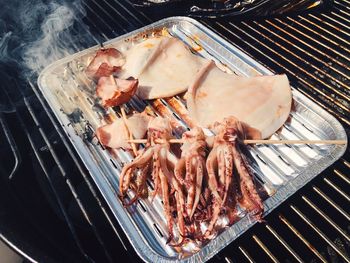 High angle view of meat on barbecue grill