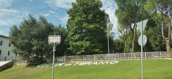 Basketball hoop on field against sky