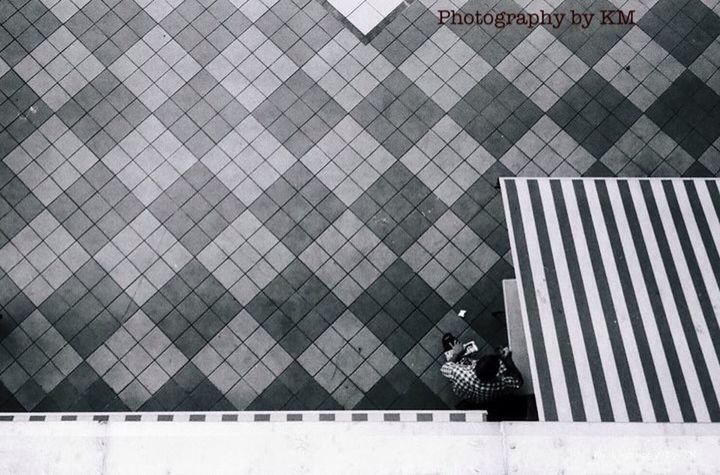 tiled floor, high angle view, tile, pattern, sidewalk, wall - building feature, paving stone, cobblestone, flooring, footpath, day, outdoors, no people, metal, domestic animals, white color, pavement, wall, floor, sunlight