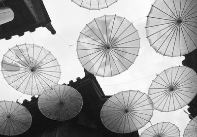 Low angle view of umbrellas for decoration against sky