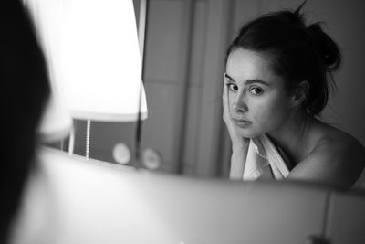 Portrait of young woman sitting with text