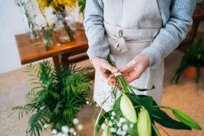 Midsection of woman holding plant