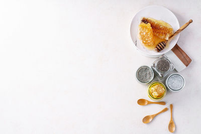 High angle view of orange fruit on table against white background