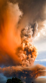 Low angle view of bonfire against sky at sunset