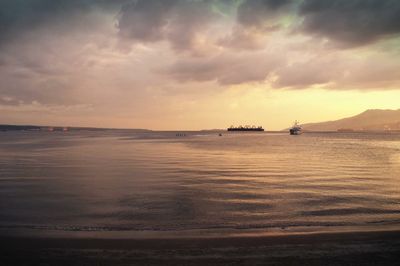 Scenic view of sea against cloudy sky