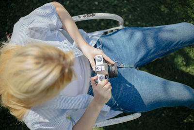 Rear view of woman photographing