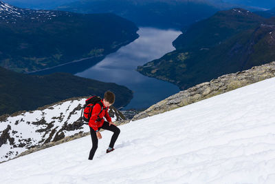 Boy hiking in snowy landscape