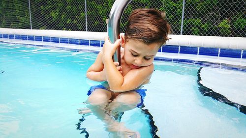 Boy playing in swimming pool