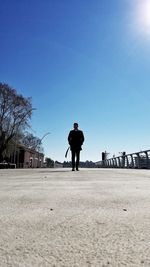 Man standing against clear blue sky