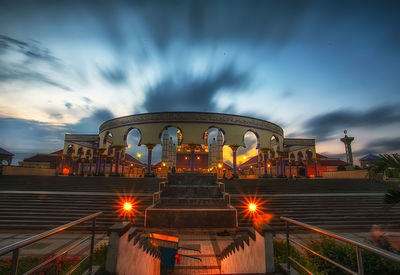 Low angle view of illuminated buildings against sky at night