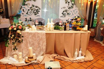 Table and illuminated candles in store