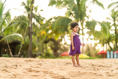 Full length of girl standing on sand