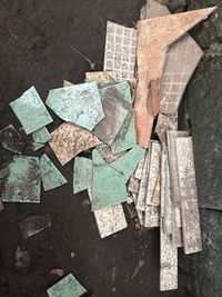 High angle view of broken tiles on footpath