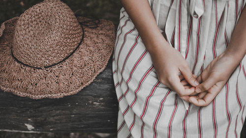 Midsection of woman wearing hat