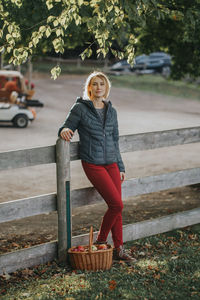 Portrait of woman standing in basket