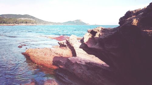 Scenic view of sea with mountain in background