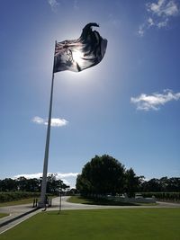 Low angle view of flags against sky