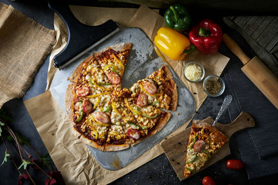 High angle view of pizza on cutting board