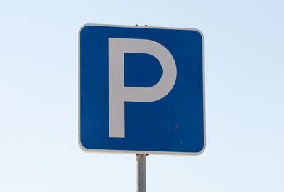 Low angle view of parking sign against clear sky