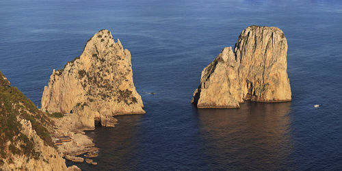 High angle view of  the faraglioni cliffs in sunset light