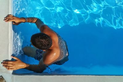 High angle view of shirtless man in swimming pool