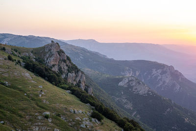 Scenic view of mountains against sky during sunset